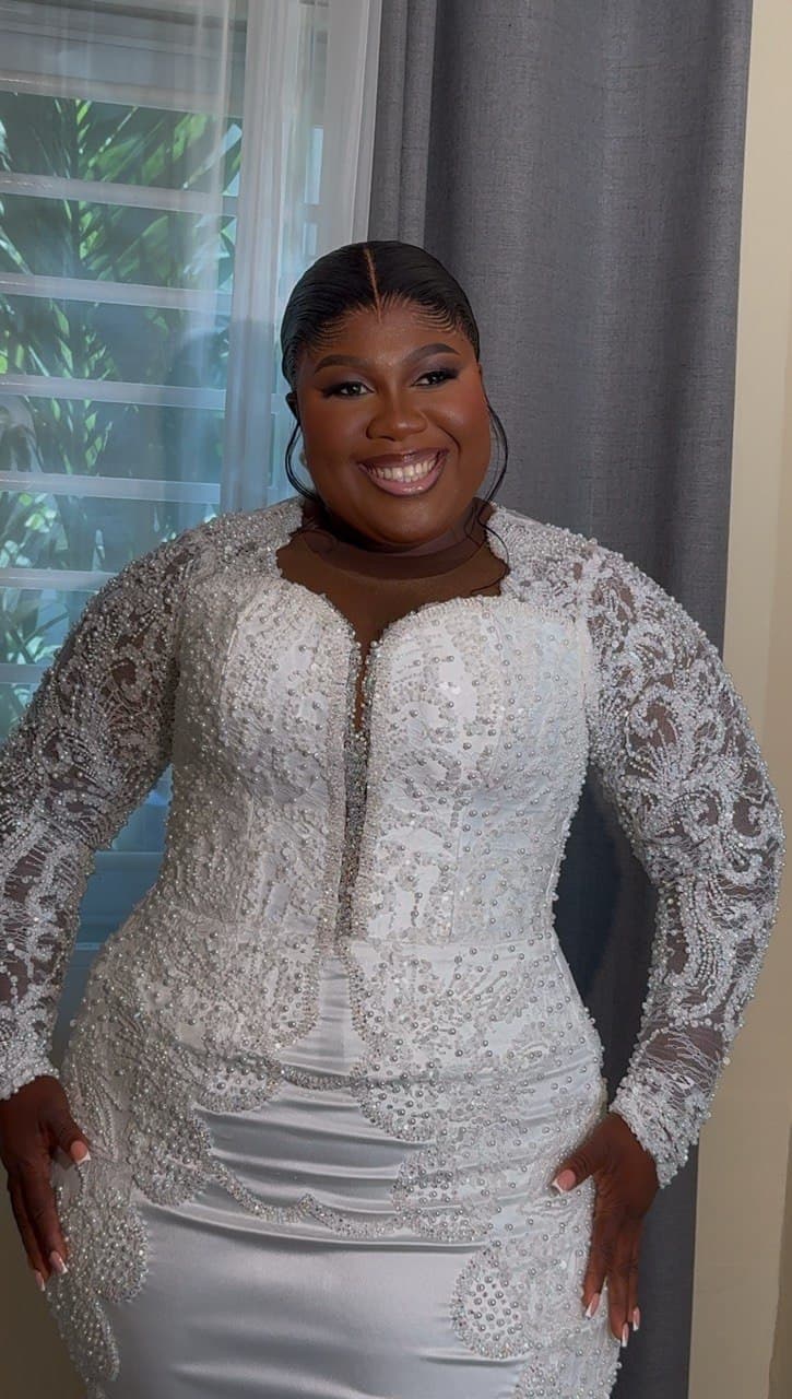 Bridal portrait, bride smiling in a beaded lace wedding gown