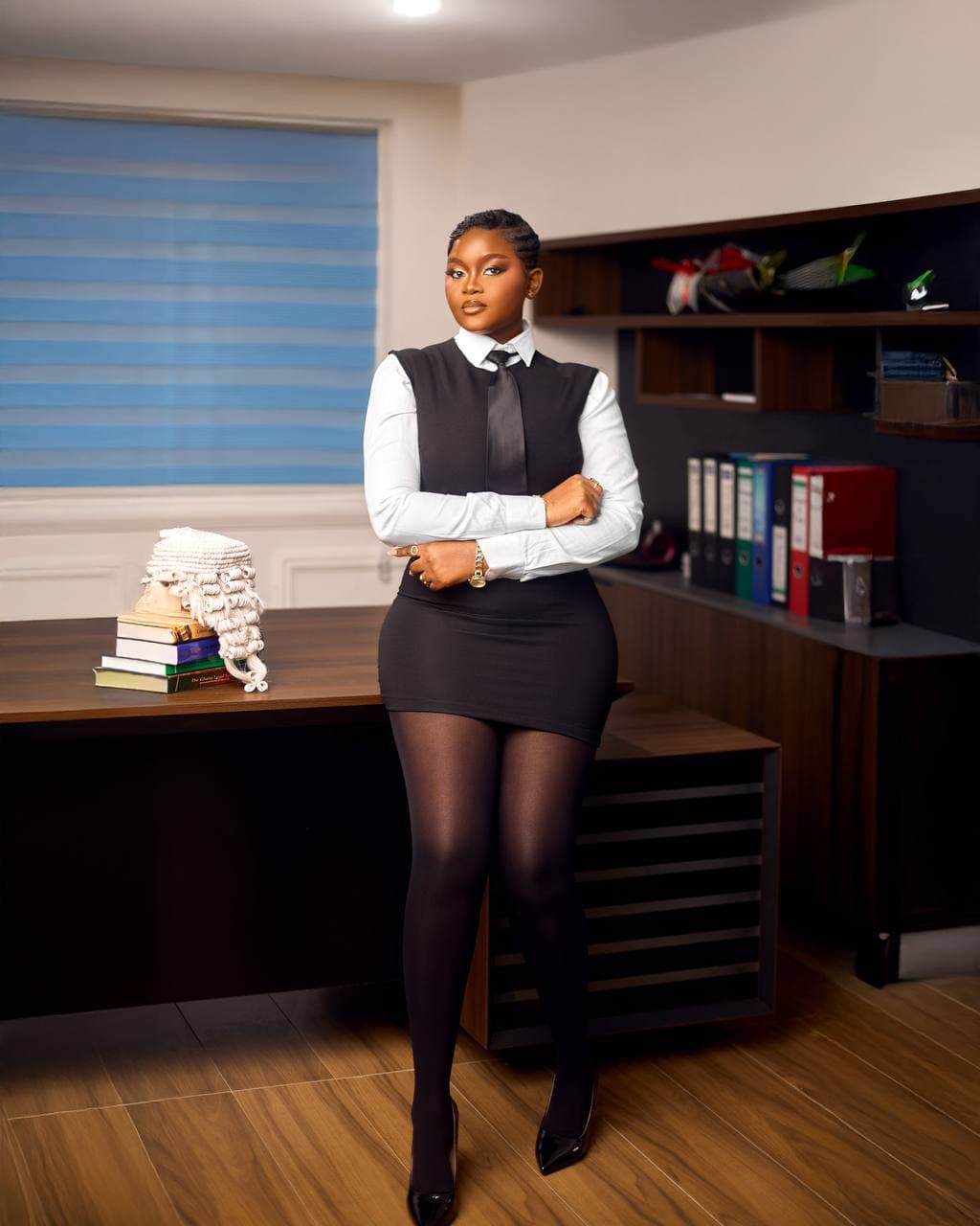 Corporate portrait of a woman in legal attire at her desk