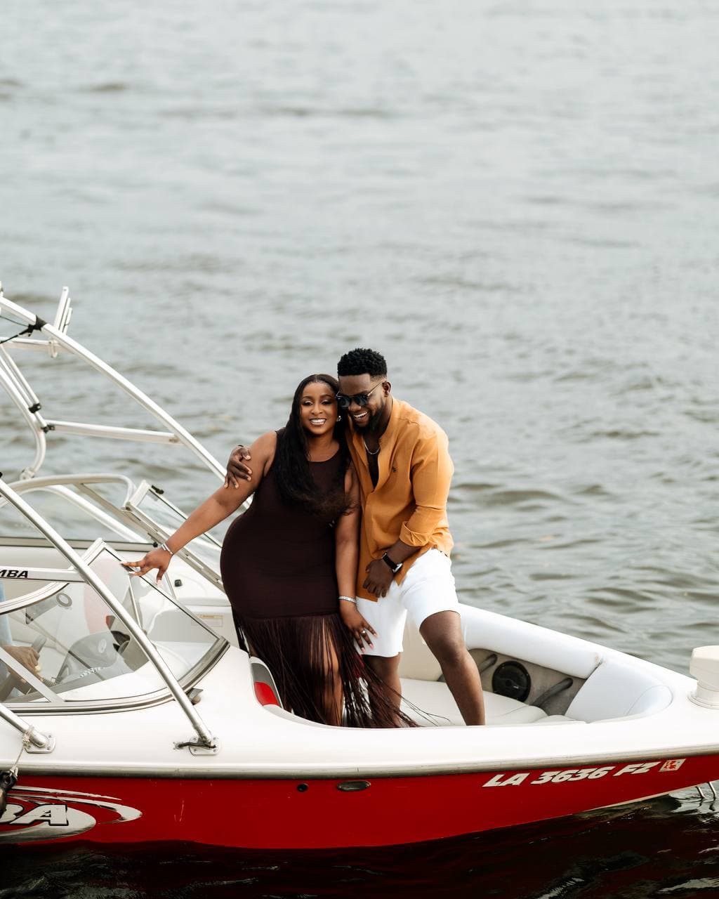 Lifestyle portrait of a couple aboard a boat on the water