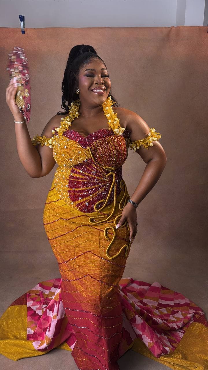 Durbar portrait in a gold and red beaded kente gown