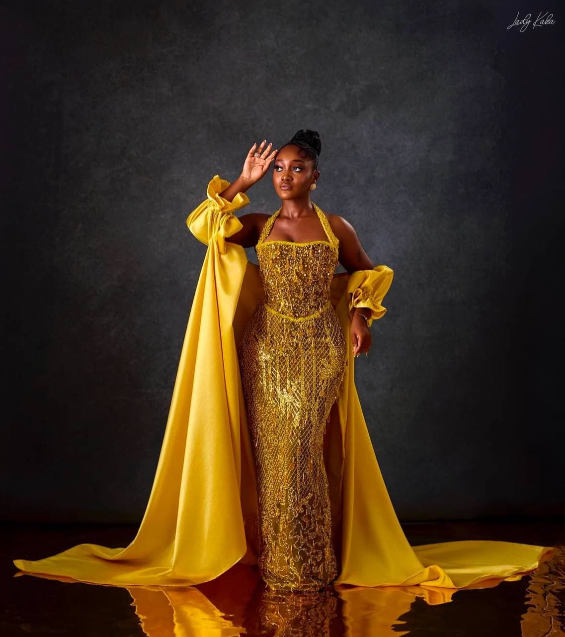 Durbar-style portrait in a red beaded kente gown